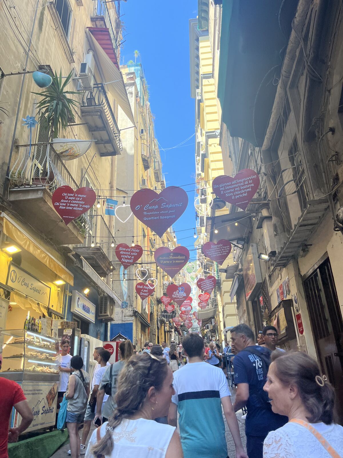 A street in Naples decorated with hand-lettered heart signs